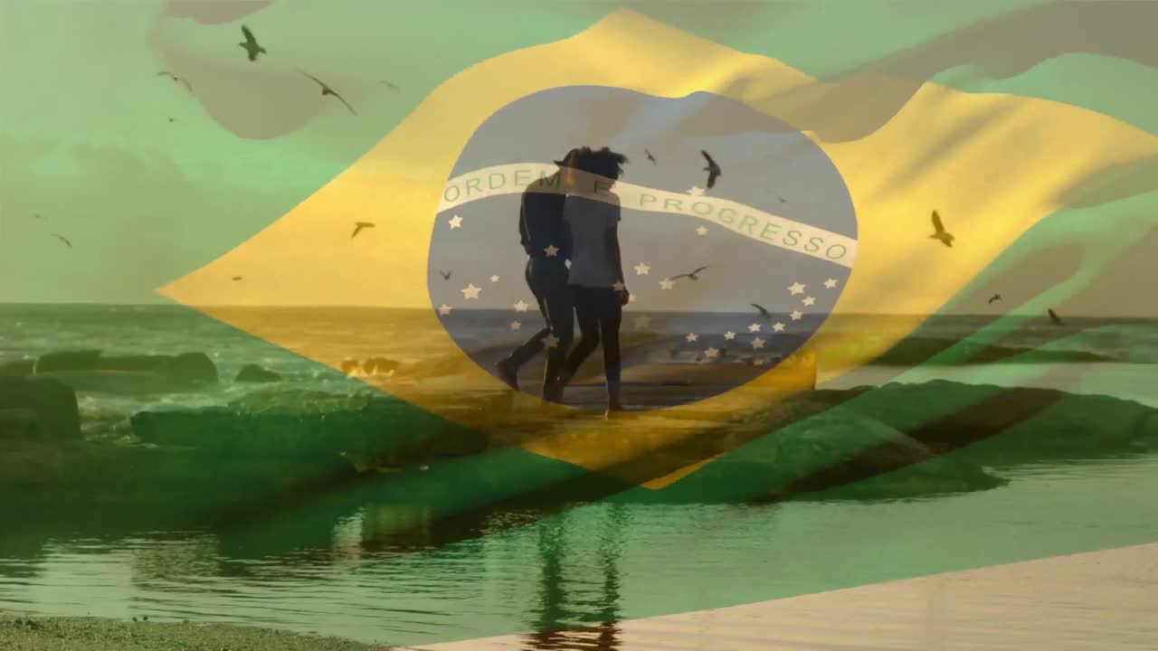 animación de agitar la bandera de brasil contra una pareja afroamericana caminando juntos en la playa