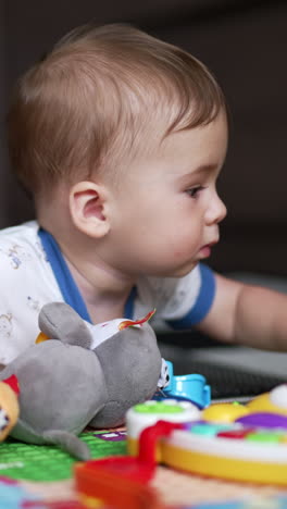 baby playing with toys on activity mat