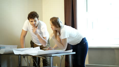 two young architects working with plans