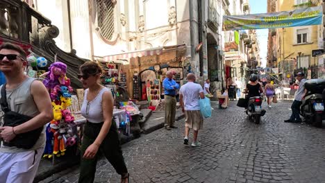 people shopping and walking in a busy street market