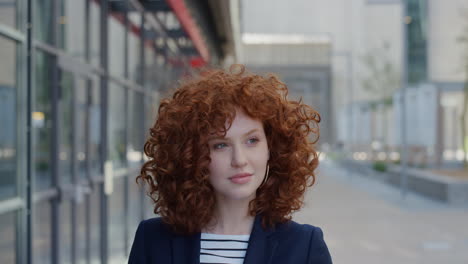 portrait-young-stylish-business-woman-smiling-pensive-red-head-enjoying-day-dreaming-lifestyle-success-beautiful-female-intern-in-urban-city-outdoors-slow-motion