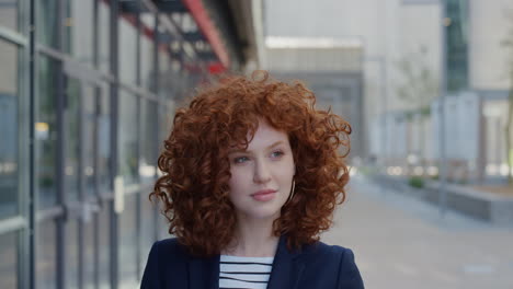 portrait young stylish business woman smiling pensive red head enjoying day dreaming lifestyle success beautiful female intern in urban city outdoors slow motion