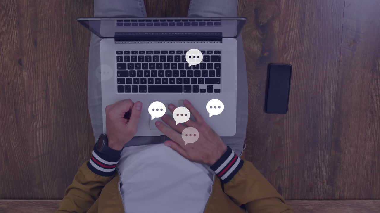 Person typing on laptop with chat bubble animation over keyboard
