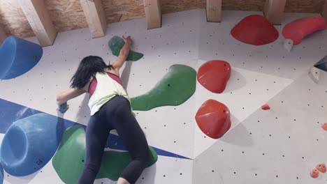 sportswoman exercising on climbing walls