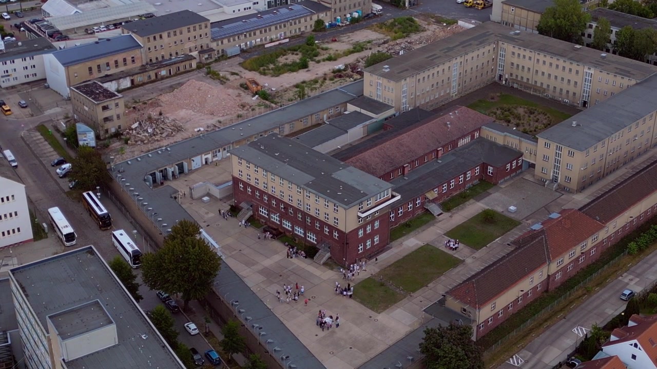 Berlin Hohenschoenhausen Memorial, a former Stasi prison, representing political persecution and communist dictatorship. Perfect aerial view static hovering drone panorama