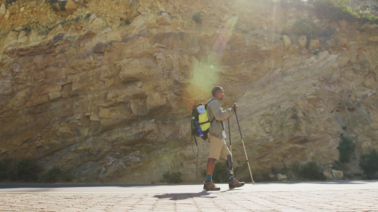 Sporty mixed race man with prosthetic leg hiking