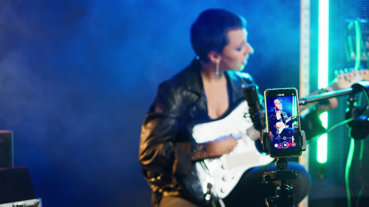 Woman playing guitar and singing live on social media