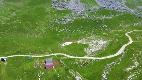 Climbing-Over-Green-Alpine-Mountains-During-Summer,-Glacial-Peaks,-Aerial-Pano