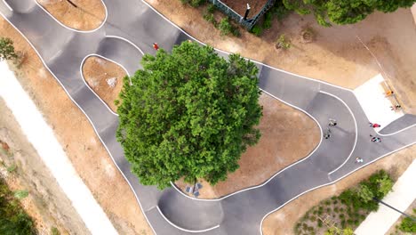 Aerial-spiral-shot-of-people-skating-around-the-skatepark-in-Montpellier