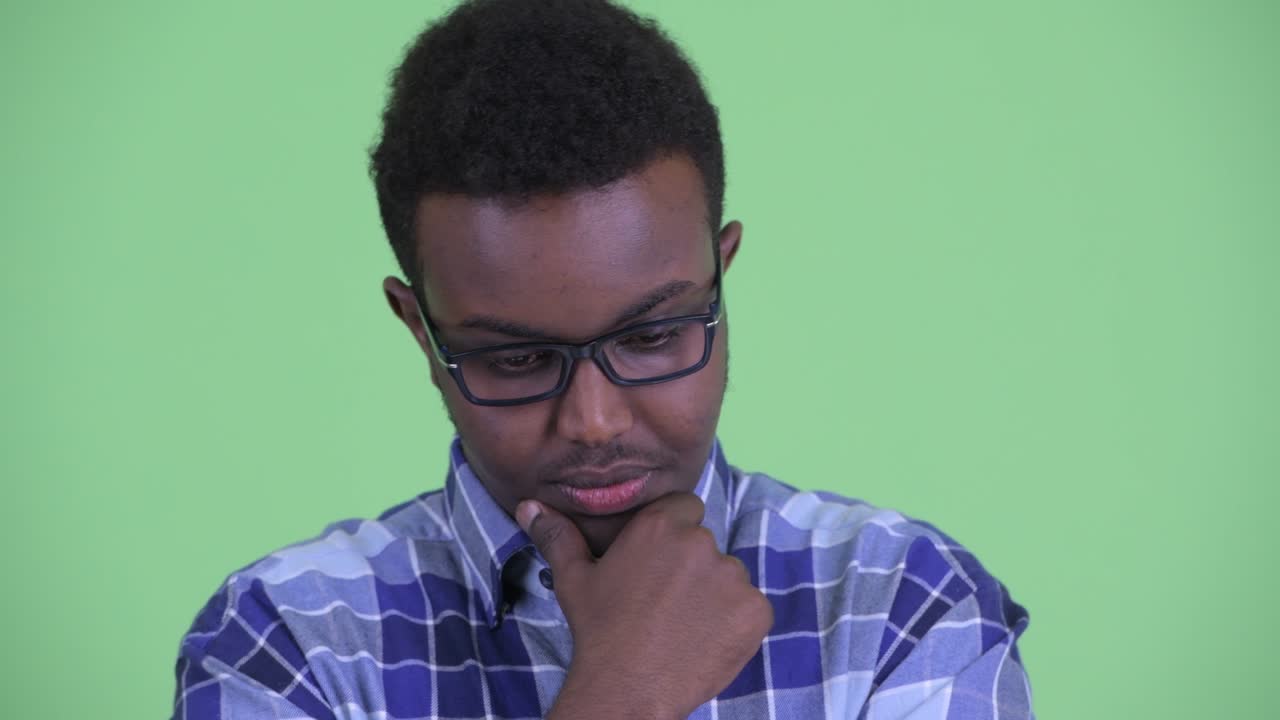 Young African hipster man with Afro hair wearing eyeglasses