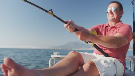 front view of a caucasian man fishing on boat