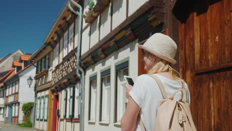 tourist with smartphone in traditional german street