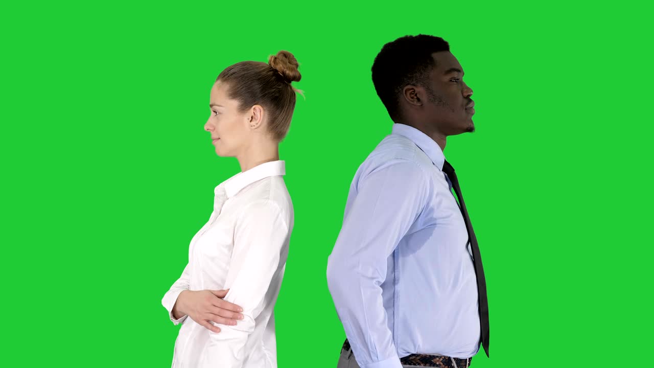 Beautiful and handsome guy standing back to back changing poses on a Green Screen, Chroma Key