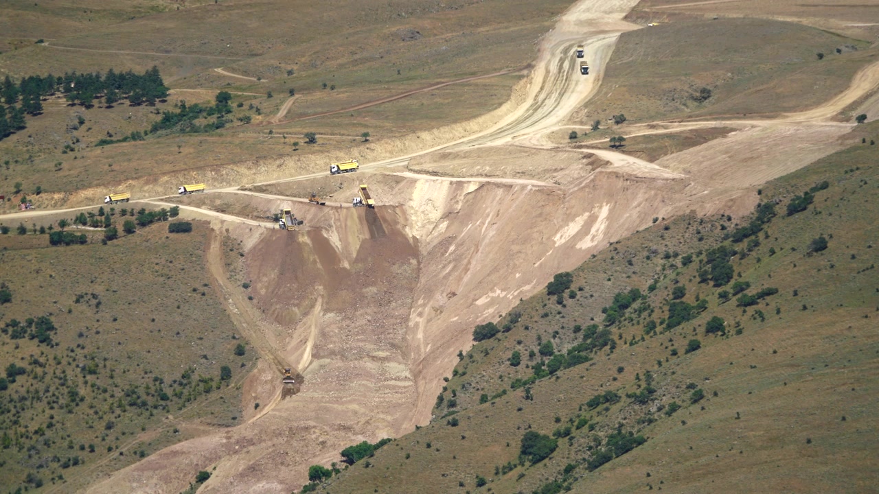 Aerial View of Heavy Machinery Working at a Large Construction Site