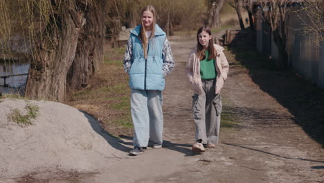 two girls walking in a countryside path
