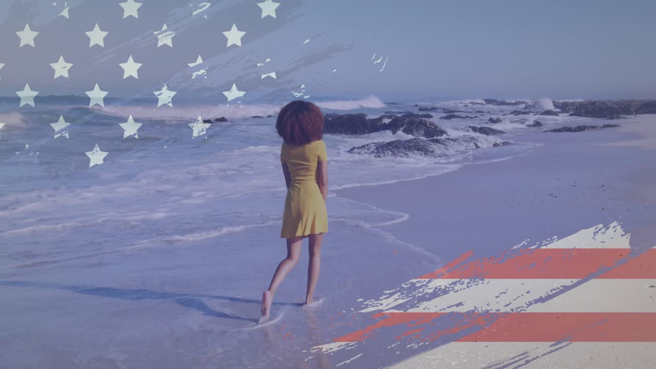 animación del diseño de la bandera estadounidense sobre la vista trasera de una mujer afroamericana caminando por la playa