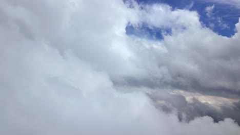 an immersive view through the pilot’s eyes from a jet cockpit flying through a dreamy cloudscape full of white storm cumulus. 4k