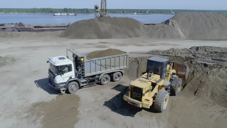 heavy equipment loading and transport at construction site