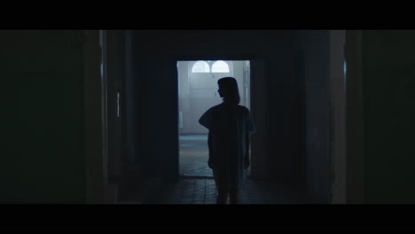 a girl in a dark corridor at night