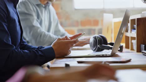 executive using mobile phone at desk in office 4k