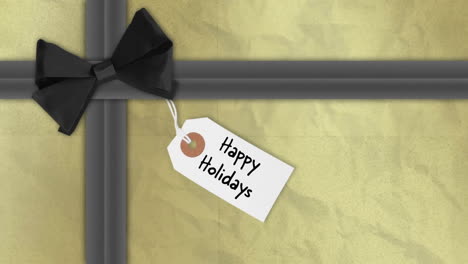 happy holidays text on gift tag with black bow animation