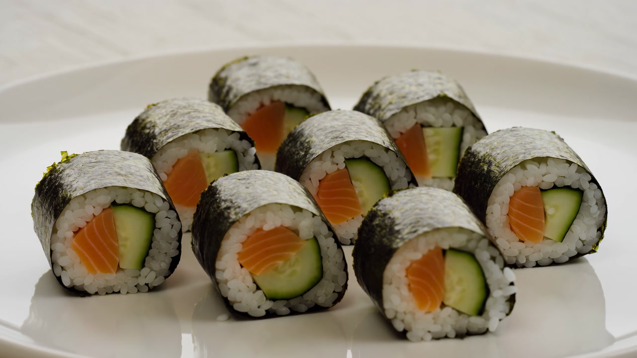 Fresh Salmon Maki On White Plate, Neat Cluster Of Sushi Rolls With Cucumber Center And Nori Wrap, Seasoned