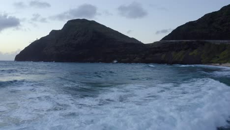 Olas-Rompiendo-En-Rocas-De-Lava-Negra-De-Hawaii-Inclinación-Hacia-Adelante-Del-Carro-Aéreo