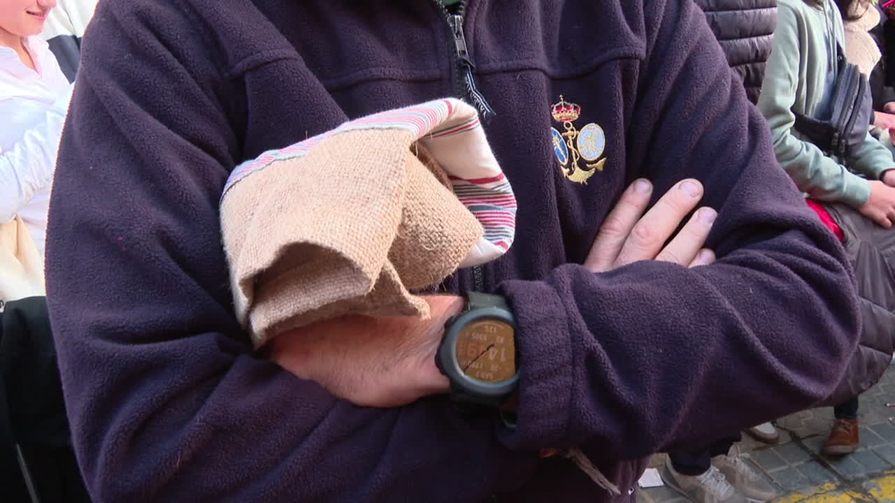 Man holding a cloth and watch
