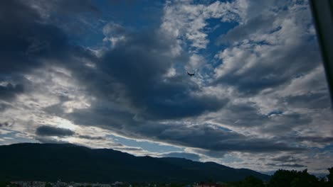 airplane flying over clouds and mountains
