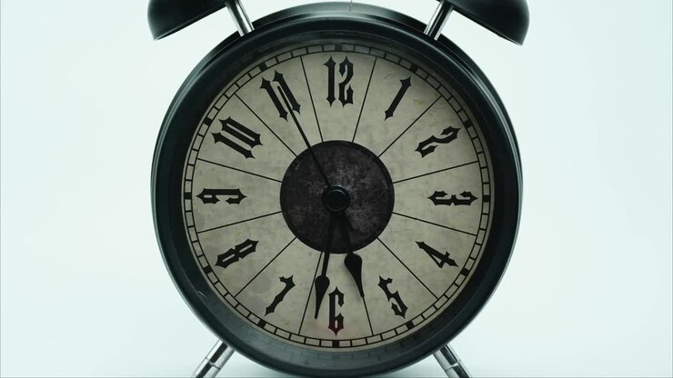 Classic Black Alarm clock isolated Showtime 05.00 am or pm.