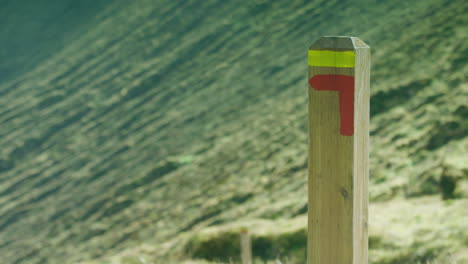 close up of a trail marker post on the slopes of the caldeira volcano, the azores