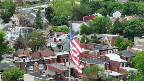 Flag-of-United-States-waving-over-American-neighborhood-houses-and-homes