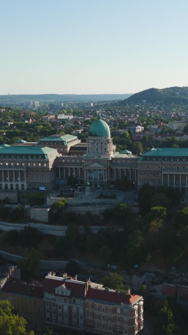 Buda Castle, a historic palace, dominating the city skyline with its prominent dome. Aerial, Vertical Video