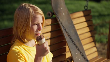 boy eating ice cream in a park