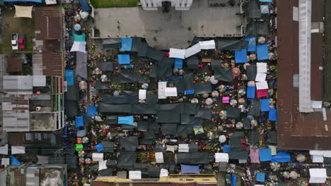 Wide-top-down-aerial-of-the-town-square-of-San-Juan-Ostuncalco-during-a-market-days-with-vendors-and-shops-open-and-people-moving-around