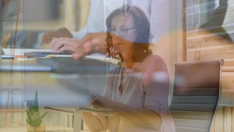 Animation-of-hands-using-computers-over-caucasian-businesswoman-in-office