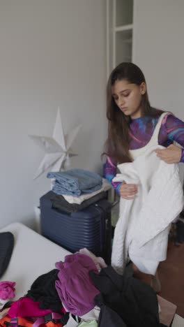 woman packing clothes for travel