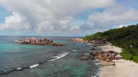 aerial view of waves breaking at the unpeopled coastline at anse songe on la digue, an island of the seychelles