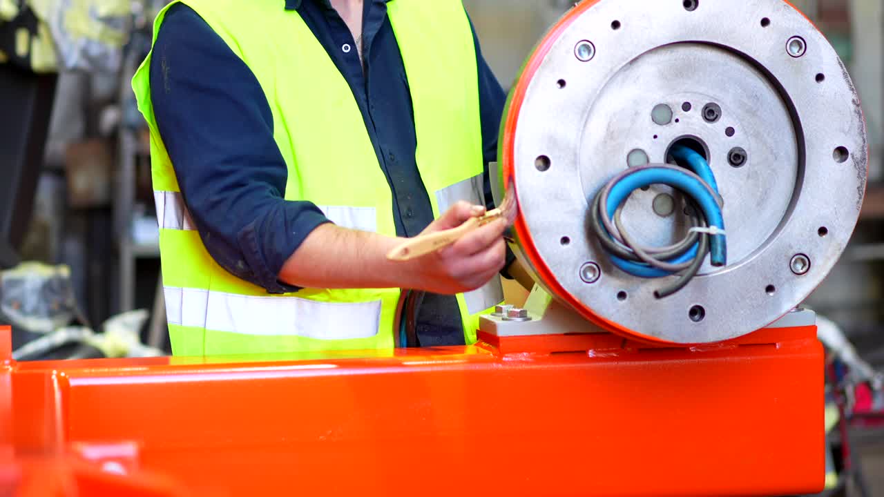 Worker painting machinery