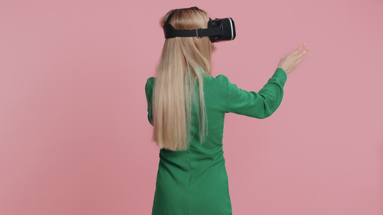 Woman using virtual reality headset helmet app to play realistic simulation 3d games watching video