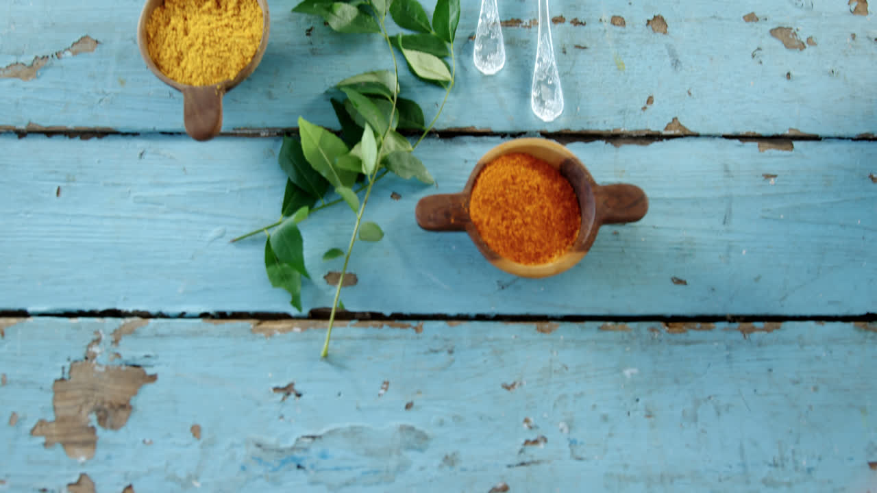 Various spices and herbs on wooden table 4k
