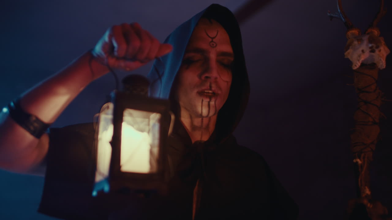 Mysterious hooded figure with a lantern