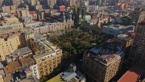 aerial drone fly of santiago de chile with plaza de armas urban central park around historic buildings at daylight