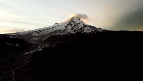 us, oregon, mt hood, , 2025-05-10 - drone view of mt hood in northern oregon at sunset with clouds curling over the peak of the mountain in the spring.