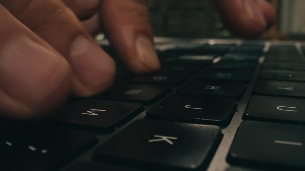 Close-up of Hand Typing on a Laptop Keyboard