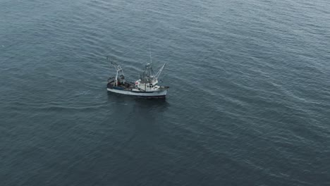 fishing trawler sailing on the saint lawrence river at early morning in quebec, canada