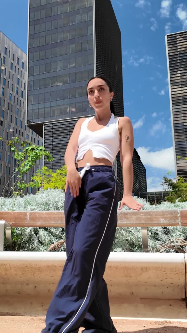 Woman posing in front of buildings