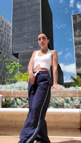 woman posing in front of buildings