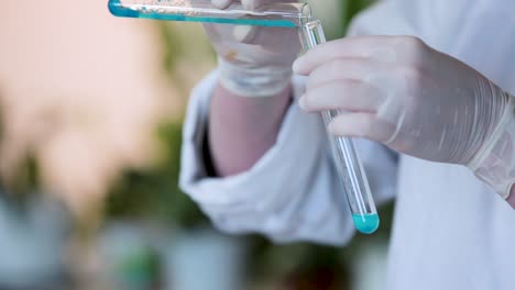 scientist conducting experiment with test tubes