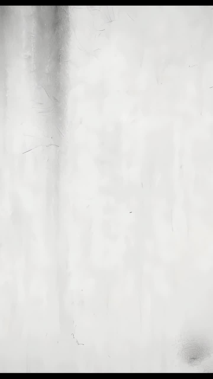Vertical video: Camera recording aged off-white wall, showing faint vertical streaks and cracks